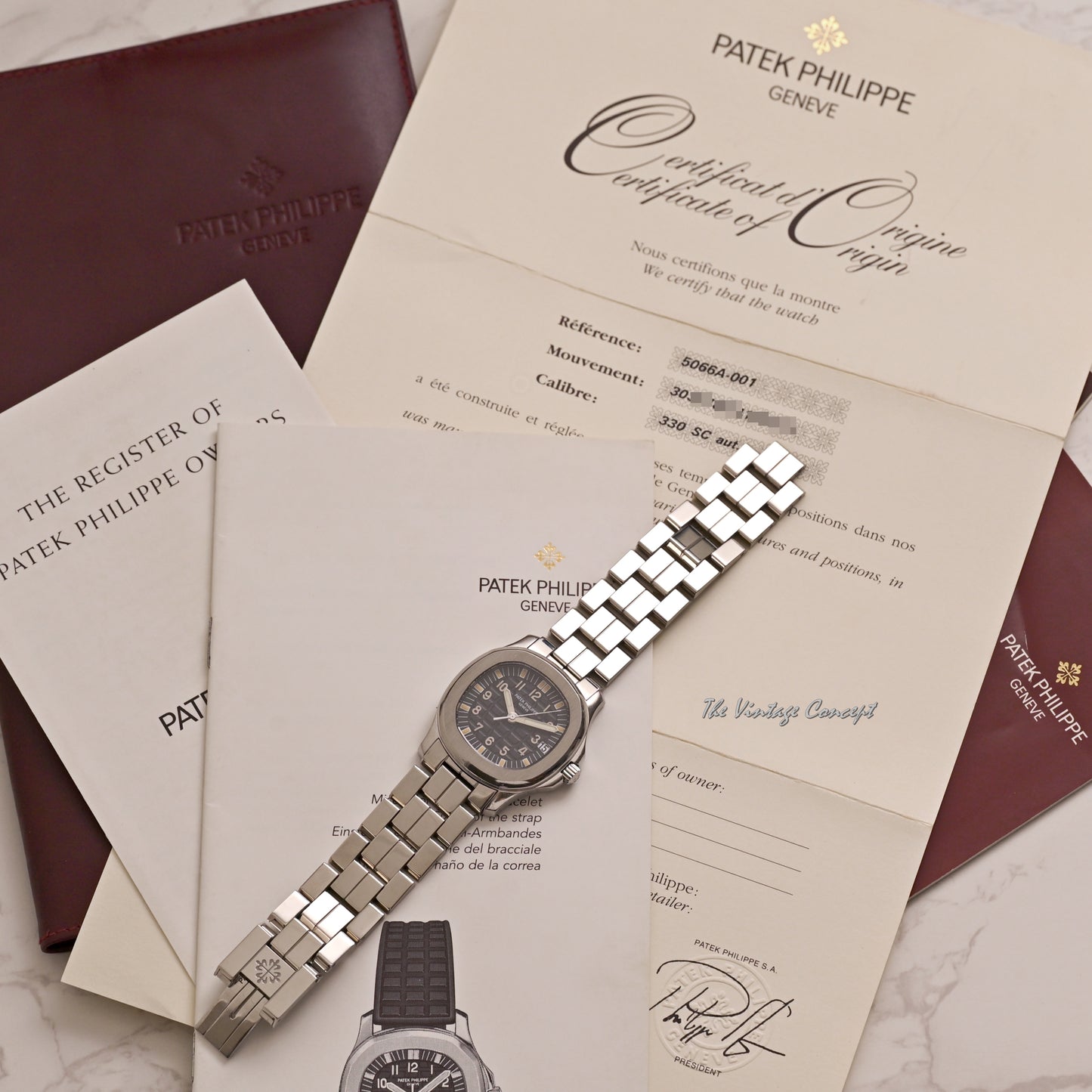 Patek Philippe Steel Aquanaut Black Dial with Steel Bracelet and Rubber Strap w/ original paper Ref. 5066A-001